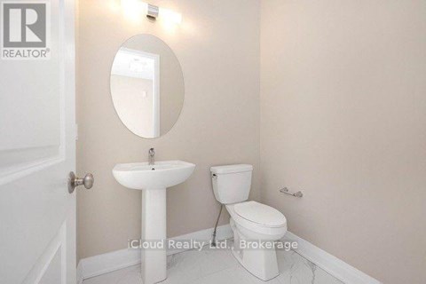 A white sink and toilet in a small bathroom.