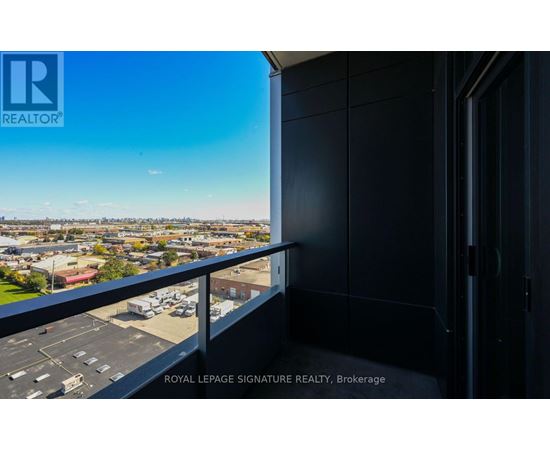 A balcony with a view of a cityscape and a sign that says "ROYAL LEPAGE SIGNATURE REALTY, Brokerage".