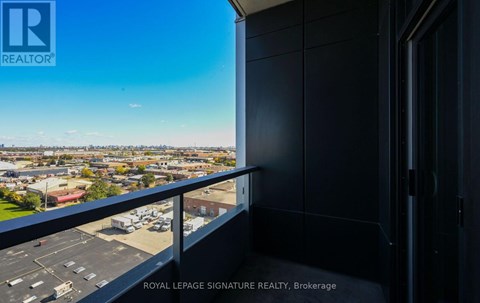A balcony with a view of a cityscape and a sign that says "ROYAL LEPAGE SIGNATURE REALTY, Brokerage".