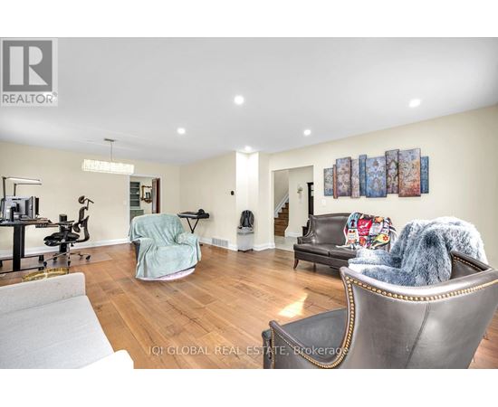 A living room with a grey leather couch and a blue chair.