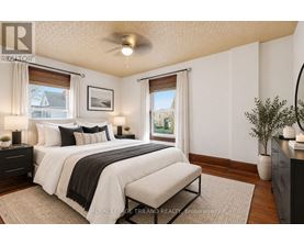 A bedroom with a large bed and a window with a view of the outside.