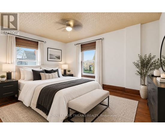 A bedroom with a large bed and a window with a view of the outside.
