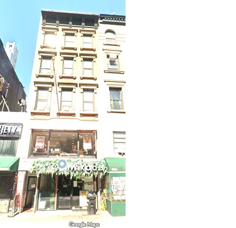 A street view of a building with a green awning and a sign that reads "MODOK".