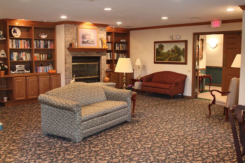 a living room with furniture and a fireplace