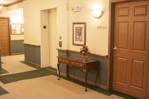 a hallway with a table and a door