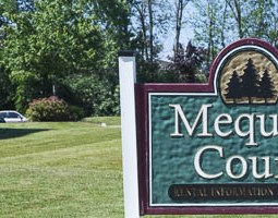 a sign for the court in the middle of a field