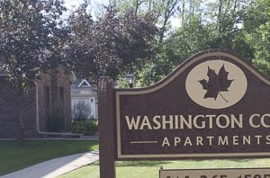 a sign court apartments in a park