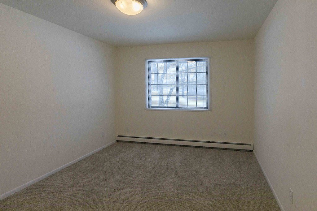 the living room of an empty house with a window