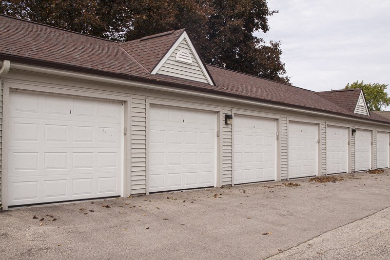 a white garage with a row of white doors