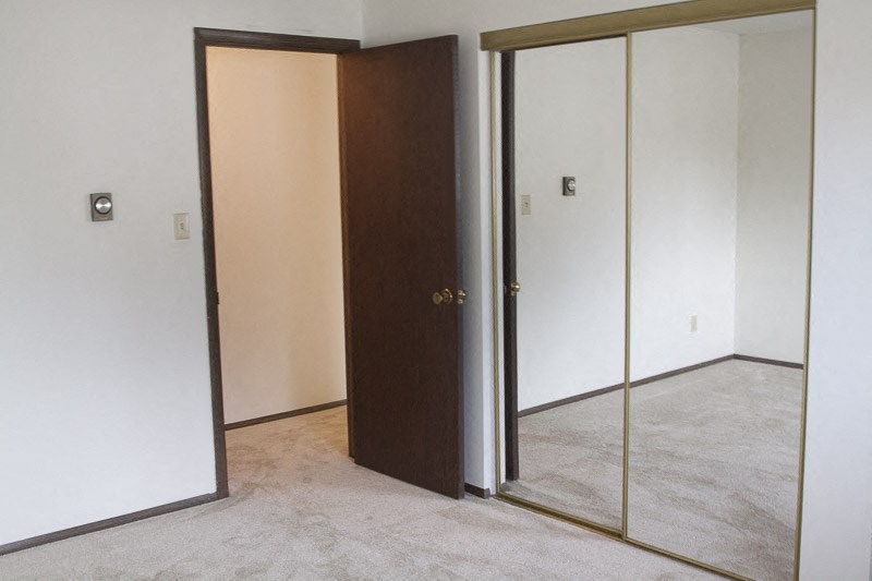 an empty room with an open closet door