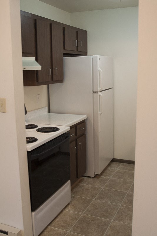 a kitchen with a stove and a refrigerator