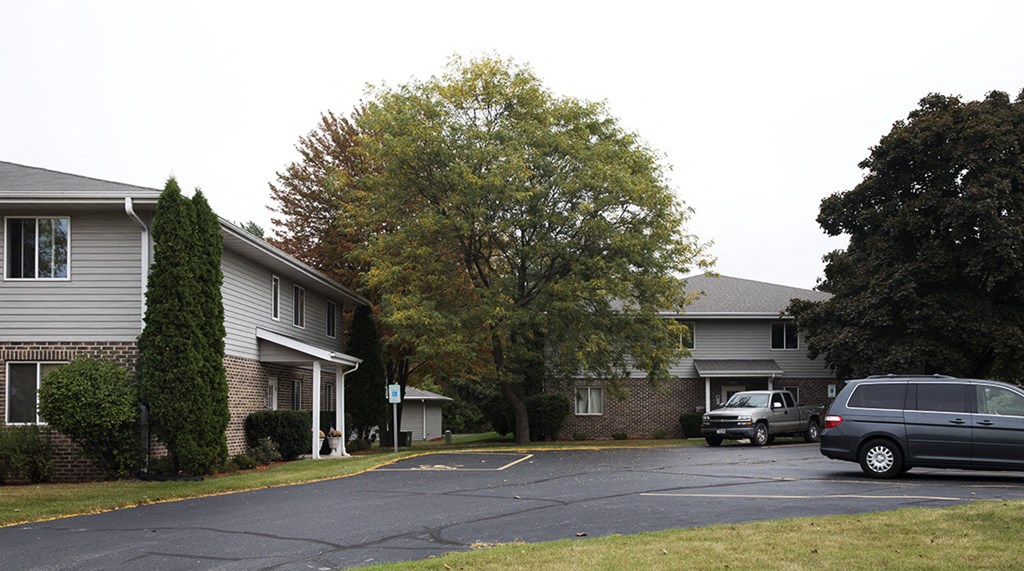 a parking lot in front of an apartment building