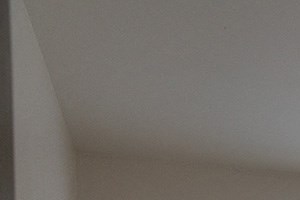 an empty room with a window and a carpeted floor