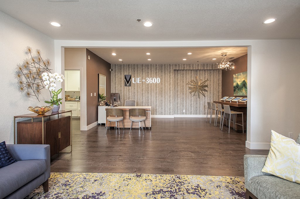 a living room and dining room with a table and chairs