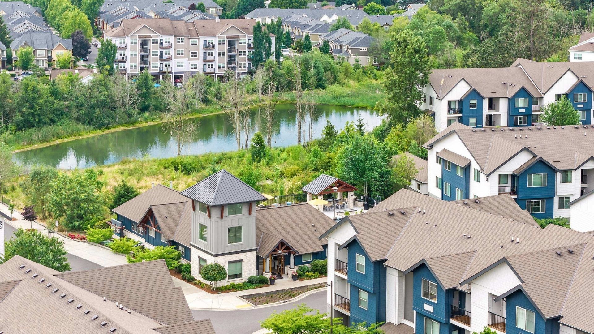 A row of houses with a lake in the background.