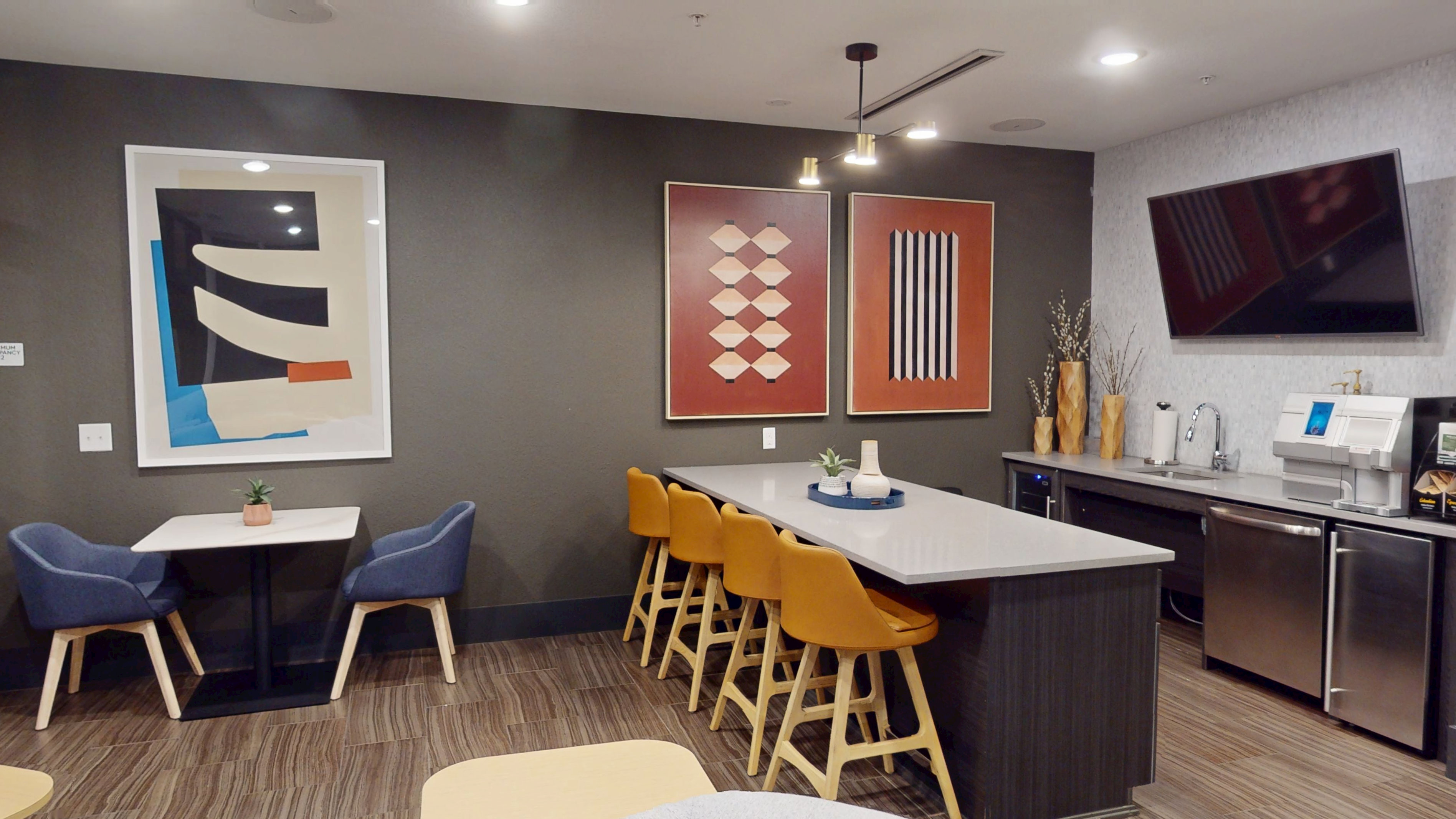 A modern kitchen with a dining table and chairs.