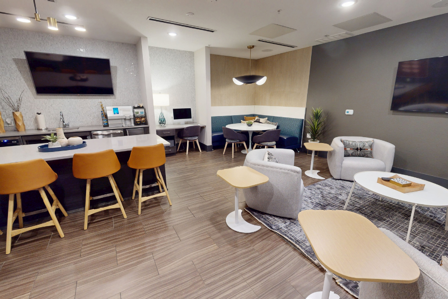 A modern kitchen with a bar area and seating.