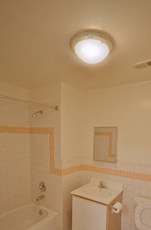 Bathroom with white tiled floor and cabinets - Photo Gallery 6