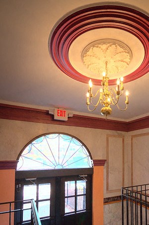 Entrance to property with golden chandelier above steps