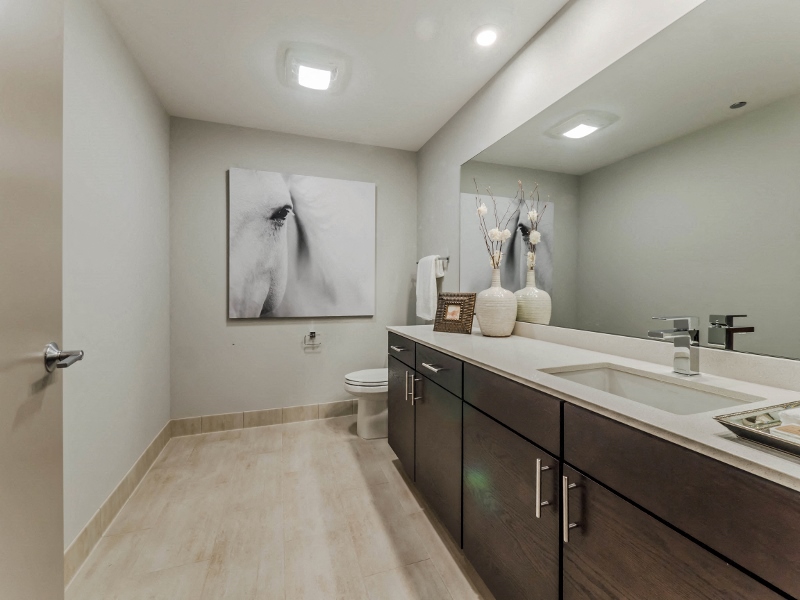 a bathroom with a toilet sink and a painting on the wall