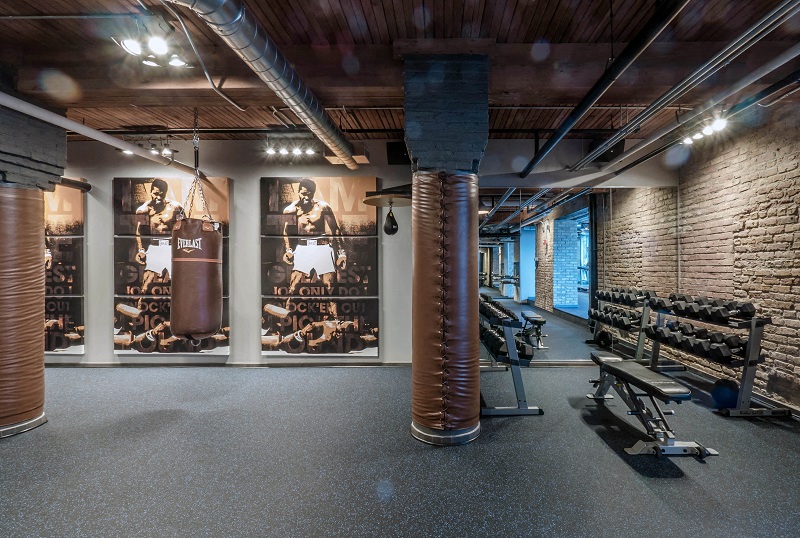 Chicago luxury apartment fitness center gym amenity with treadmills, bikes, boxing punching bags, free weights, and ellipticals