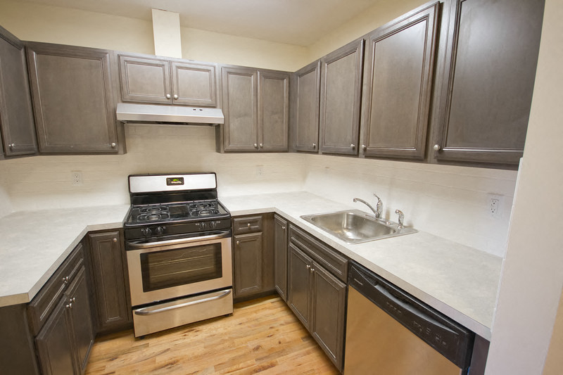 a kitchen with stainless steel appliances and wooden cabinets