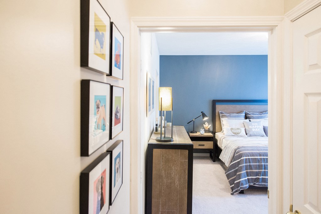 a bedroom with a bed and pictures on the wall