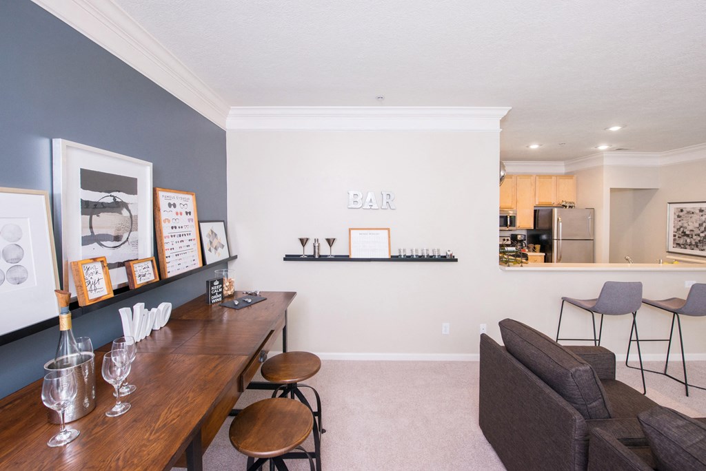 a living room with a dining table and a bar