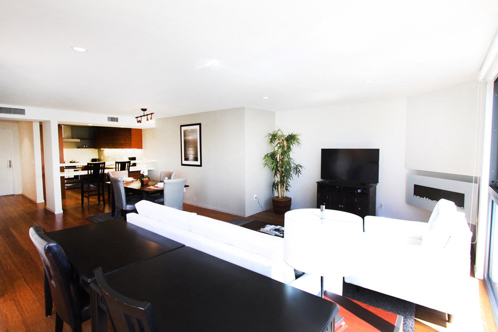 a living room with a white couch and a black table