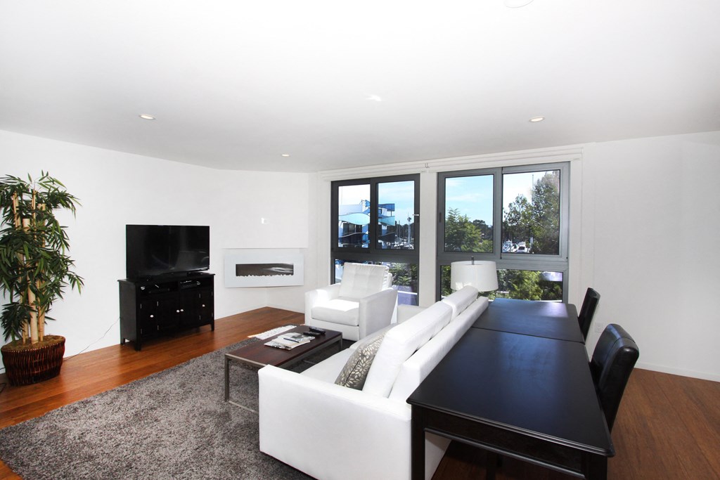 a living room with a white couch and a black table