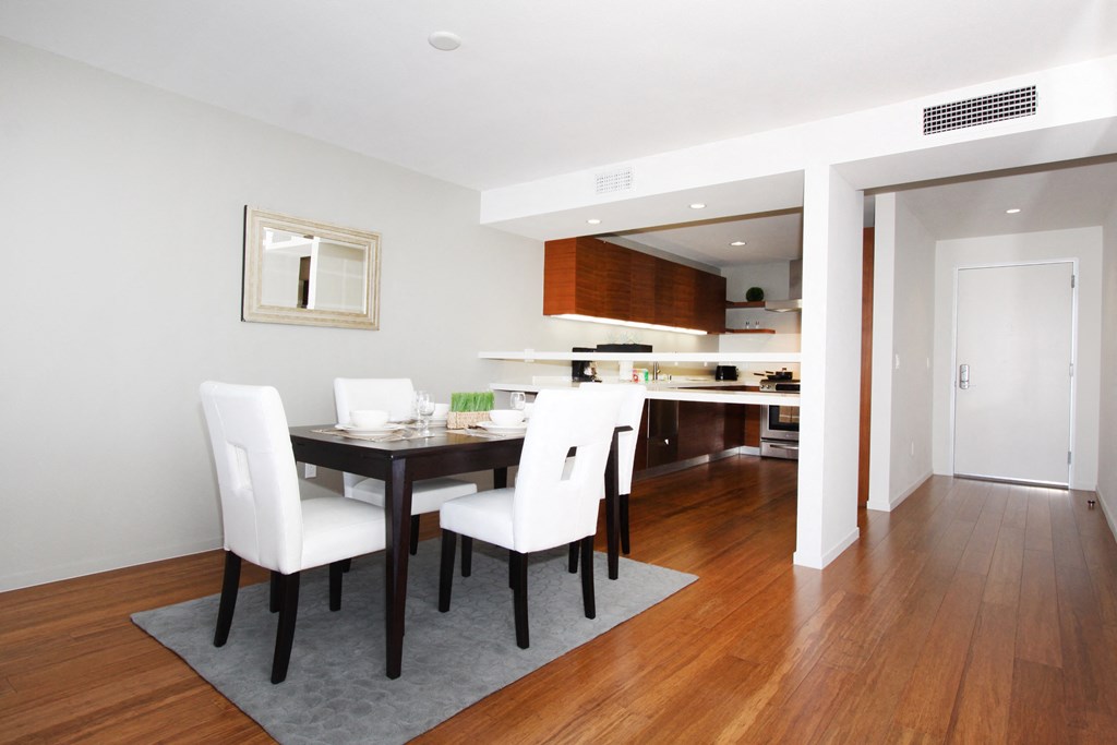 a dining room with a table and chairs and a kitchen