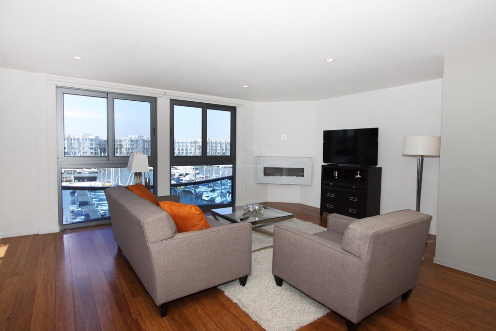 a living room with a couch and a chair and a television