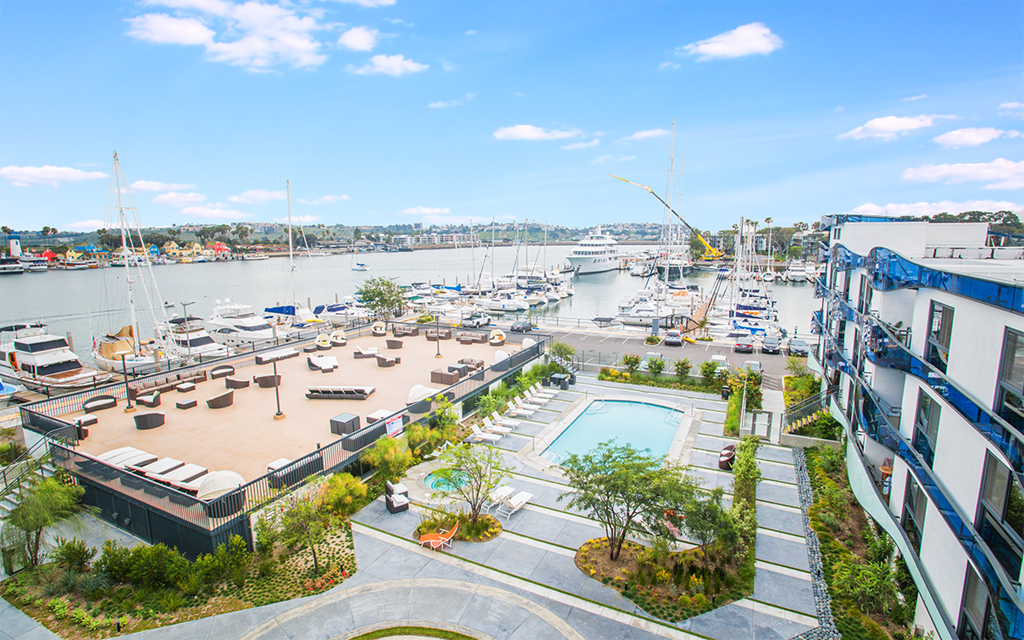 an aerial view of a marina with a pool and boats in the water