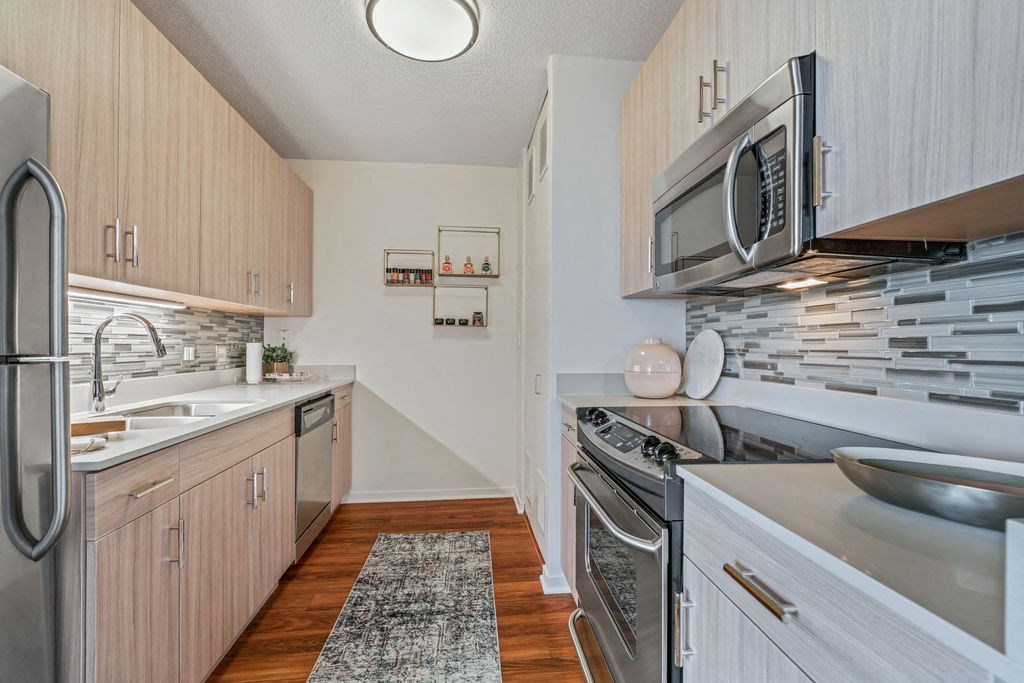 Galley kitchen with light cabinets and stainless steel appliances at Kingsbury Plaza in River North Chicago at Kingsbury Plaza, Chicago, 60654