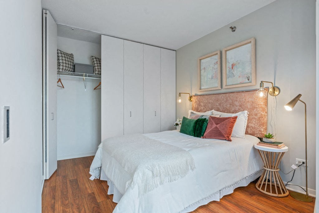 Bedroom with closet and Brazilian cherry wide plank floors at Kingsbury Plaza apartments at Kingsbury Plaza, Chicago, Illinois