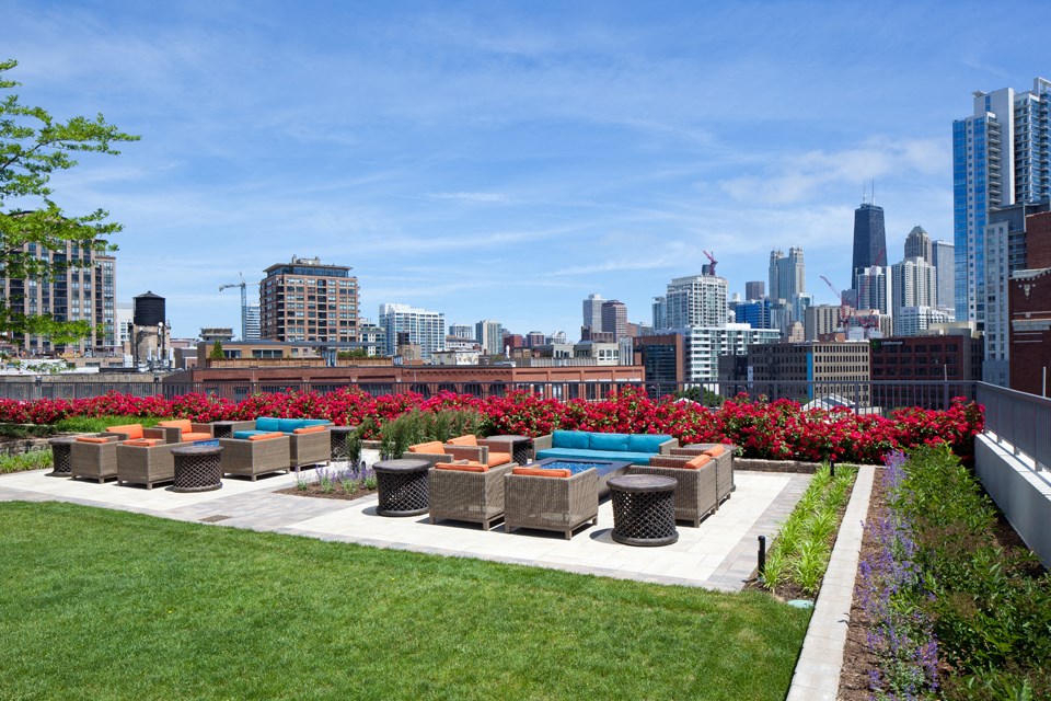 Outdoor terrace seating around fire pits during daytime at Kingsbury Plaza, Illinois