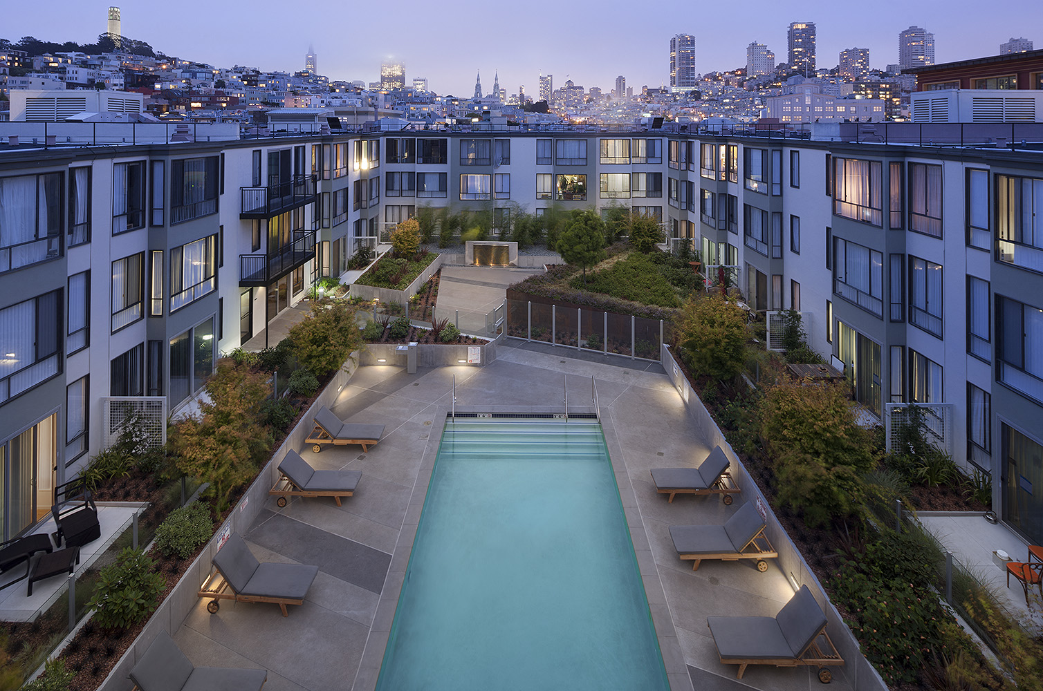 an apartment pool with a view of the city