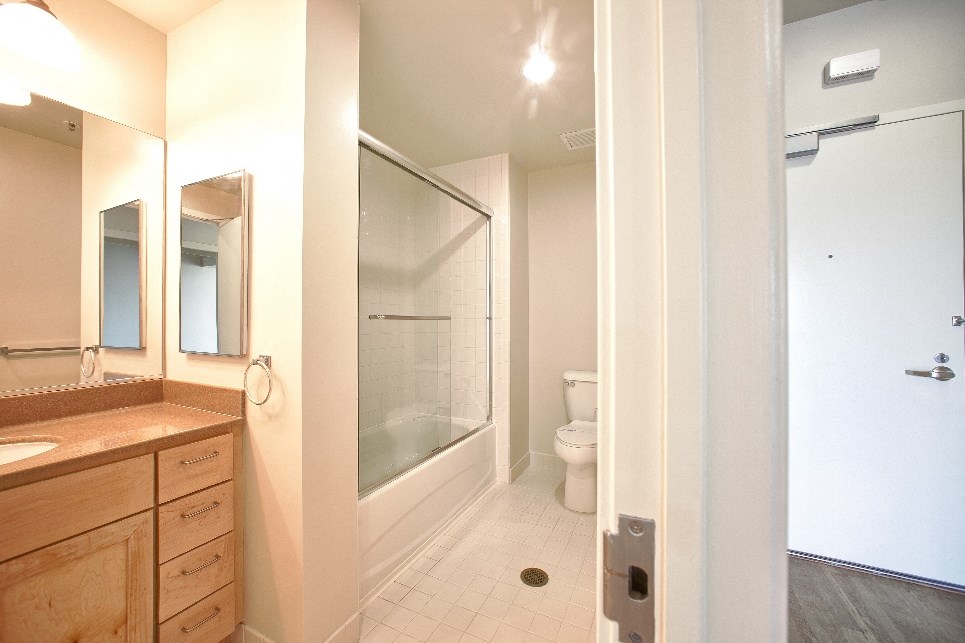 a bathroom with a shower and a sink and a toilet