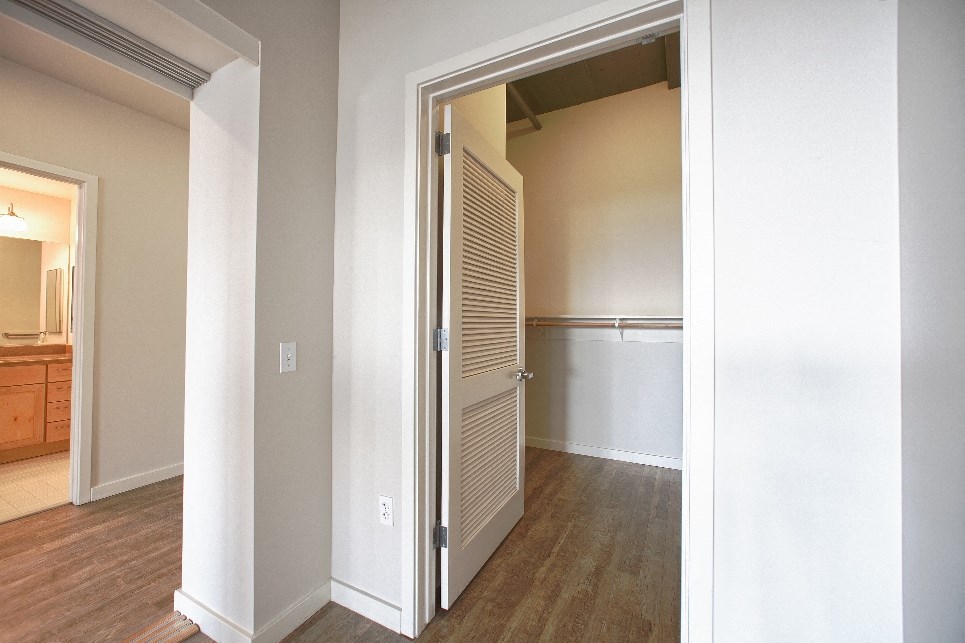 an open door leading into a living room with a closet