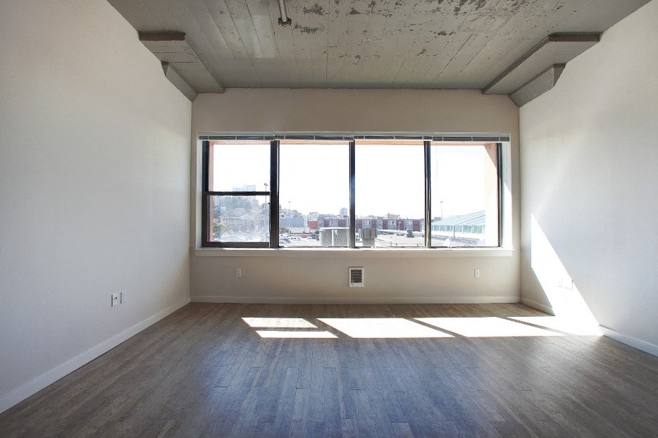 an empty living room with a large window