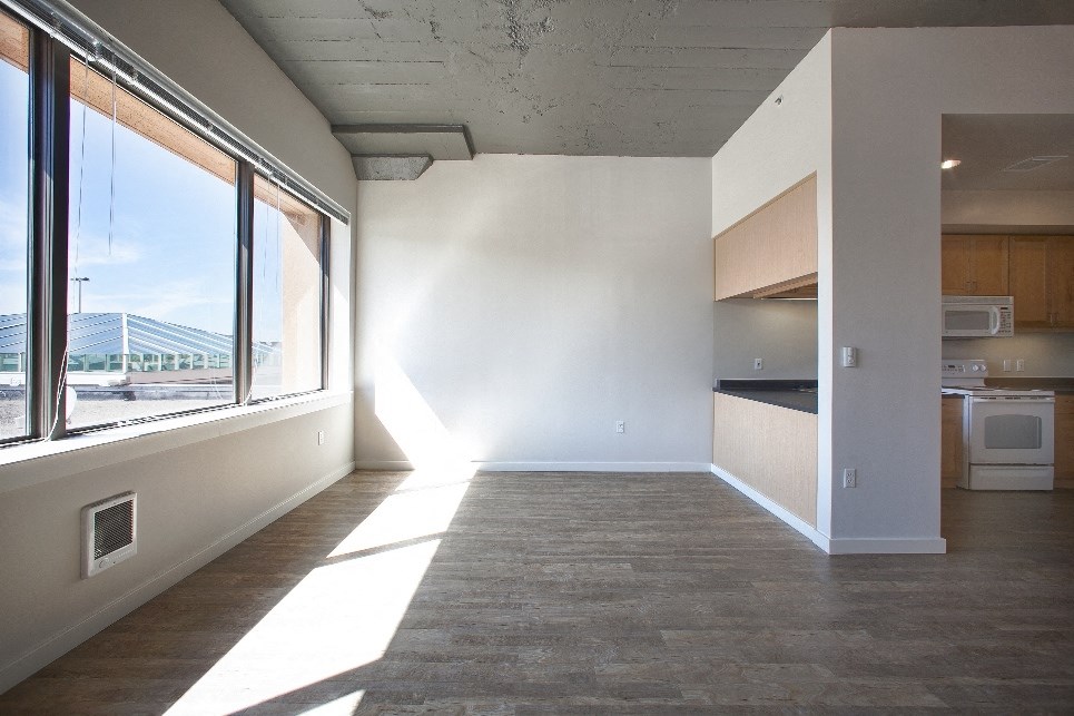 an empty living room with a large window