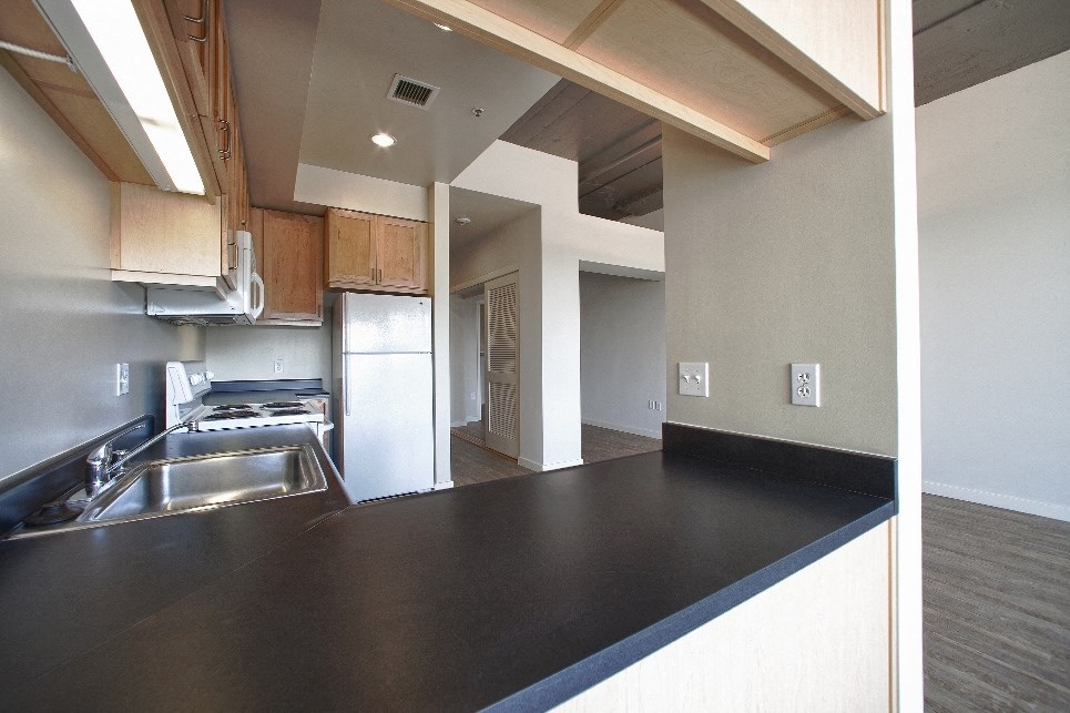 a kitchen with a black counter top and a sink