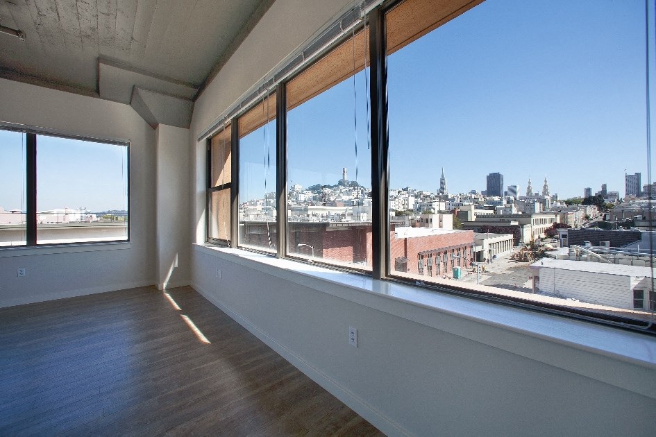 a view of the city from the window of an apartment