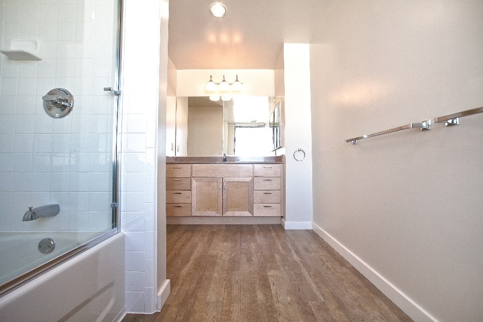 a bathroom with a shower and a sink and a mirror