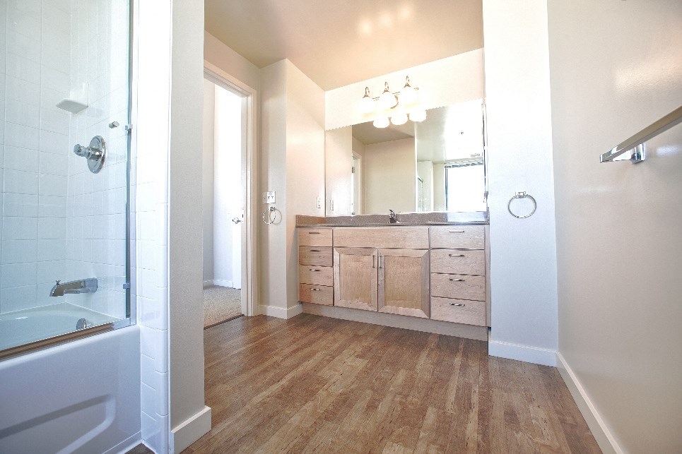 a bathroom with a shower and a sink and a mirror