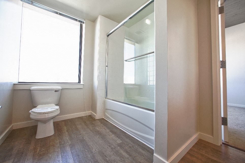 an empty bathroom with a toilet and a shower