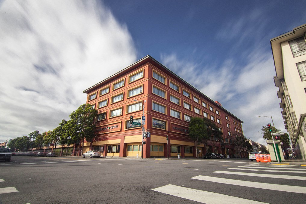 a large brick building on the corner of a city street