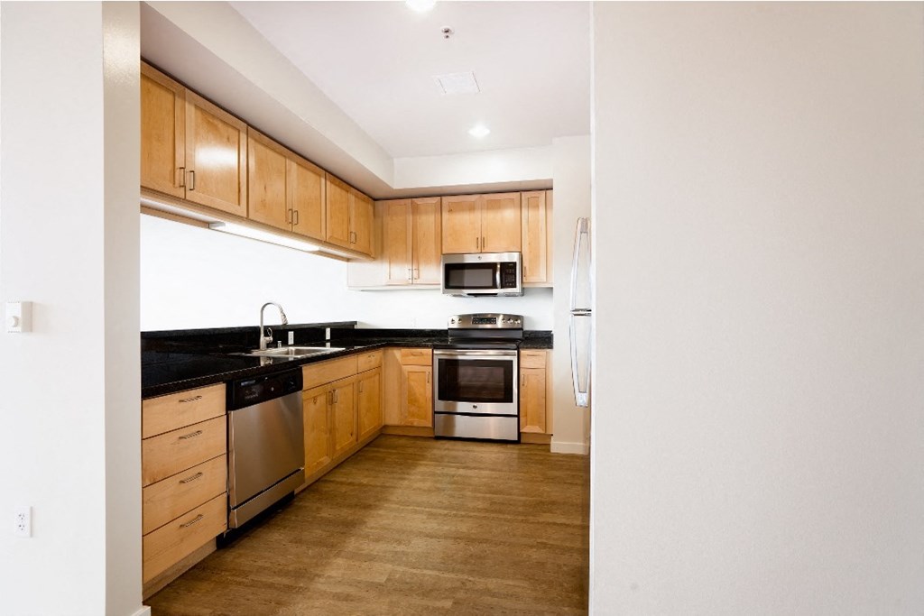 a kitchen with wooden cabinets and stainless steel appliances