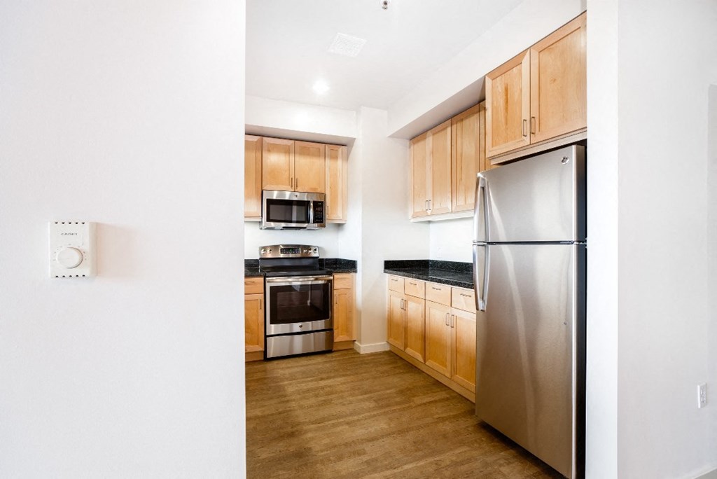a kitchen with wooden cabinets and stainless steel appliances