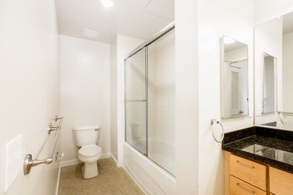 a bathroom with a toilet and a glass shower